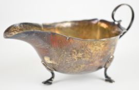Mappin & Webb George V hallmarked silver sauce boat with wavy edge and scroll handles, raised on