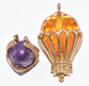 Two 9ct gold charms, one in the form of a basket set with amethyst and the other a hot air balloon