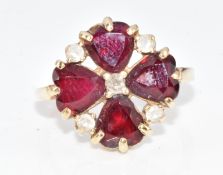 A 14k gold ring set with four heart cut synthetic rubies and paste, size M, 4.3g
