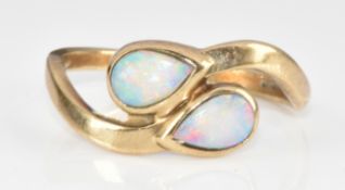 A 9ct gold ring set with two pear cut opal cabochons, 1.8g, size M