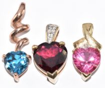 Three 9ct gold pendants one set with a heart shaped garnet and two set with topaz, 4.9g