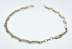 A 9ct gold bracelet set with diamonds (one link needs small repair), 10.9g