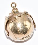 A 9ct gold and silver Masonic ball charm opening to reveal a cross and Masonic symbols, 7.8g