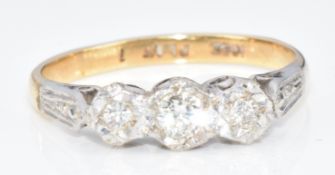 An 18ct gold ring set with three diamonds in a platinum setting, 2.4g, size I