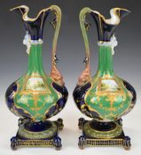 Pair of 19thC Sèvres style French porcelain ewers with hand decorated landscape cartouches signed