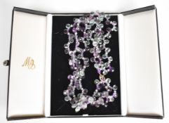 A beaded necklace made up of pearls, amethysts, fluorite and aquamarine, with 14k gold clasp