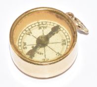 A 9ct gold charm set with a compass with embossed St Christopher to the back, 3g, 1.7cm