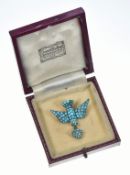 Victorian brooch in the form of a swallow set with turquoise cabochons and glass eyes, holding a