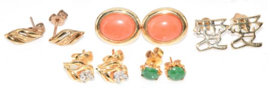 A pair of 14k gold earrings set with coral cabochons (2.6g), two pairs of 14k gold earrings, one