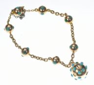 A c1900 14ct gold bracelet made up of spheres set with turquoise, with sphere shaped locket also set