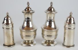 Two pairs of hallmarked silver peppers, the larger pair Chester 1906, maker Walker & Hall, height