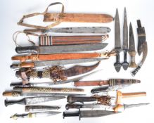 Fourteen mainly North African tribal knives / short swords including a silver wire bound dagger,