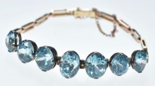 A 9ct rose gold bracelet set with seven oval cut zircon, 12.4g, 17cm