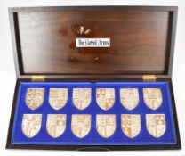 Set of twelve hallmarked silver 'Royal Arms' armorial shield shaped plaques to commemorate Her