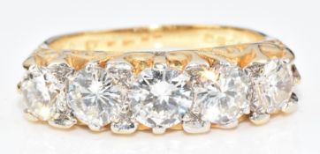 An 18ct gold ring set with five round brilliant cut diamonds measuring approximately 0.5ct, 0.4ct,