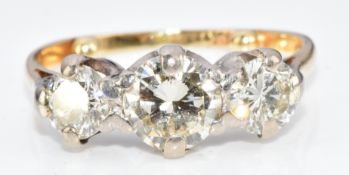 An 18ct gold ring set with three round cut diamonds of approximately 0.8ct, 0.4ct and 0.45ct, 3.
