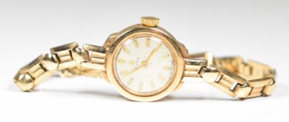 Cyma 9ct gold ladies wristwatch with gold hands and baton hour markers, silver dial and signed