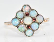 A 9ct gold ring set with nine opal cabochons and four garnets in a square setting, 1.7g, size H