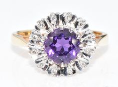 An 18ct gold ring set with a round cut amethyst surrounded by diamonds, 4.3g, size K/L