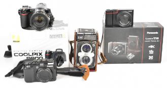 Three digital cameras comprising Panasonic Lumix TZ100, Canon G11 and Nikon Coolpix 8800 together