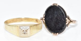 A 9ct gold ring set with onyx (size J, 1.7g) and a 14k gold ring set with a diamond (size M, 1.4g)