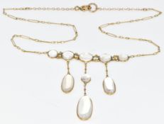 A c1900 yellow metal necklace set with moonstone cabochons, 6g, 40cm. Tests as 9k