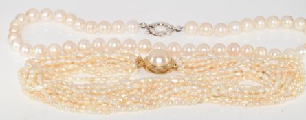 A single strand of cultured pearls with silver bolt clasp and a twelve strand freshwater pearl