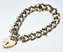 A 9ct gold curb link bracelet with heart padlock clasp, 55.8g, 19cm
