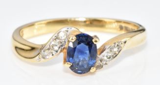 An 18ct gold ring set with an oval cut sapphire and diamonds, 2.4g, size J