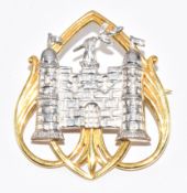 A 9ct gold bi-coloured brooch in the form of a castle, 8g, 3 x 2.7cm