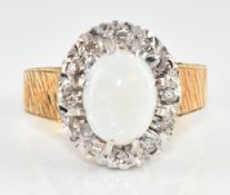 An 18ct gold ring set with an opal cabochon surrounded by diamonds, 4.8g, size J/K