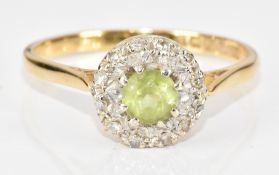 An 18ct gold ring set with a round cut peridot surrounded by diamonds, 3.2g, size Q