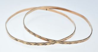 Two rose gold bangles with cut out decoration, 12.4g (tests as 14k gold)