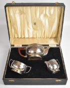 Art Deco hallmarked silver three piece teaset, the teapot having Bakelite or similar stepped