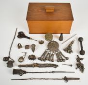 A collection of white metal tribal items including Omani halka brooch, two Omani kohl pots, three