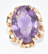 A 9ct gold ring set with an oval cut amethyst, 4.8g, size M