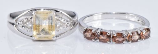 Two 9k white gold rings, one set with a citrine and topaz and the other zircons, with