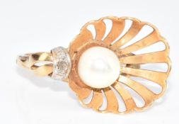 A 333 gold ring set with a pearl and diamond in a shell shaped setting, 3.9g, size O