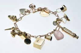A 9ct gold charm bracelet with thirteen 9ct gold charms including whistle, pram, iron, key,