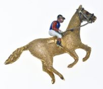A 9ct gold brooch in the form of a jockey on horseback set with enamel, 4.8g, 3.2cm
