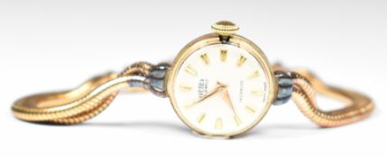 Trebex 9ct gold ladies wristwatch with gold hands and hour markers, silver dial and 21 jewel