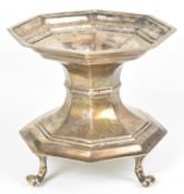 Edward VII or George V hallmarked silver octagonal stand raised on four scroll feet, with