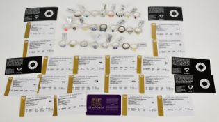 Twenty four silver rings including opal, ruby, peridot, garnet, topaz, green amethyst, marcasite,