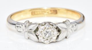 An 18ct gold ring set with a diamond in a platinum setting, 2.7g, size M