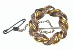 A yellow metal brooch set with split pearls (one pearl missing), 3.6g, 2.7cm