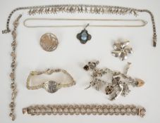 A silver charm bracelet with nine silver charms including dog, motorbike, fish, etc (46g), 900 grade