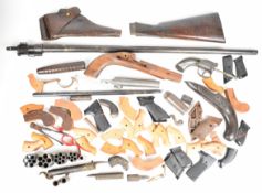 A collection of gun parts including pepperbox revolver, transitional revolver frame, breech-