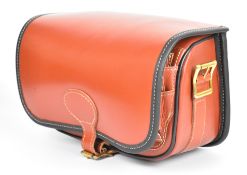 Brown leather shotgun cartridge loader's bag with shoulder strap, unused in original box.