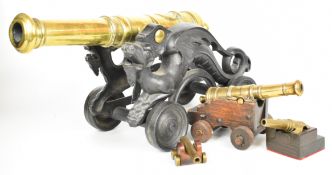 Four model desk or signalling cannon, the largest with cast iron base in the form of dragons and