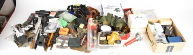 A large collection of gun and shooting accessories including Mini-Lazer Gunlight, Vlulite 12V Gun